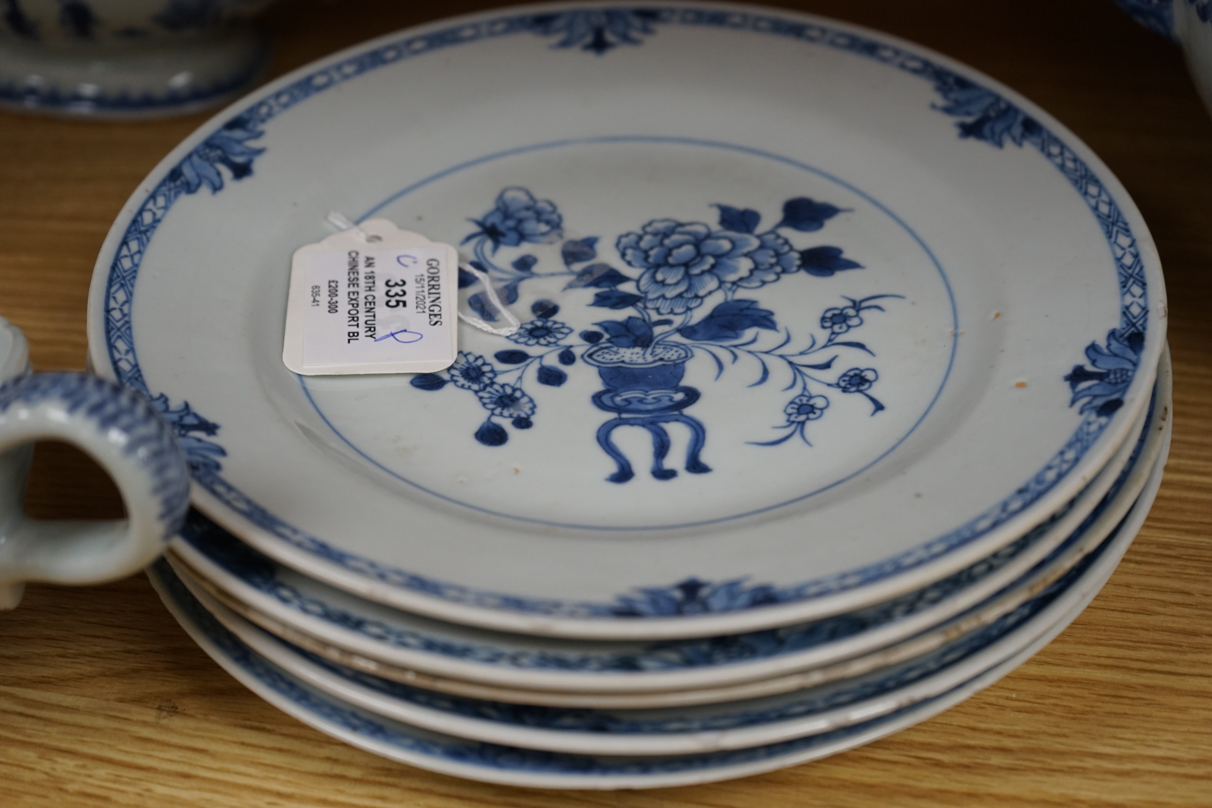 An 18th century Chinese Export blue and white octagonal tureen and cover, decorated with birds and flowers, a pair of similar sauceboats and five plates decorated with urns of flowers